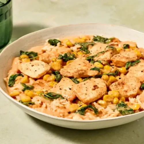Bol de poulet crémeux au maïs sur un lit de riz